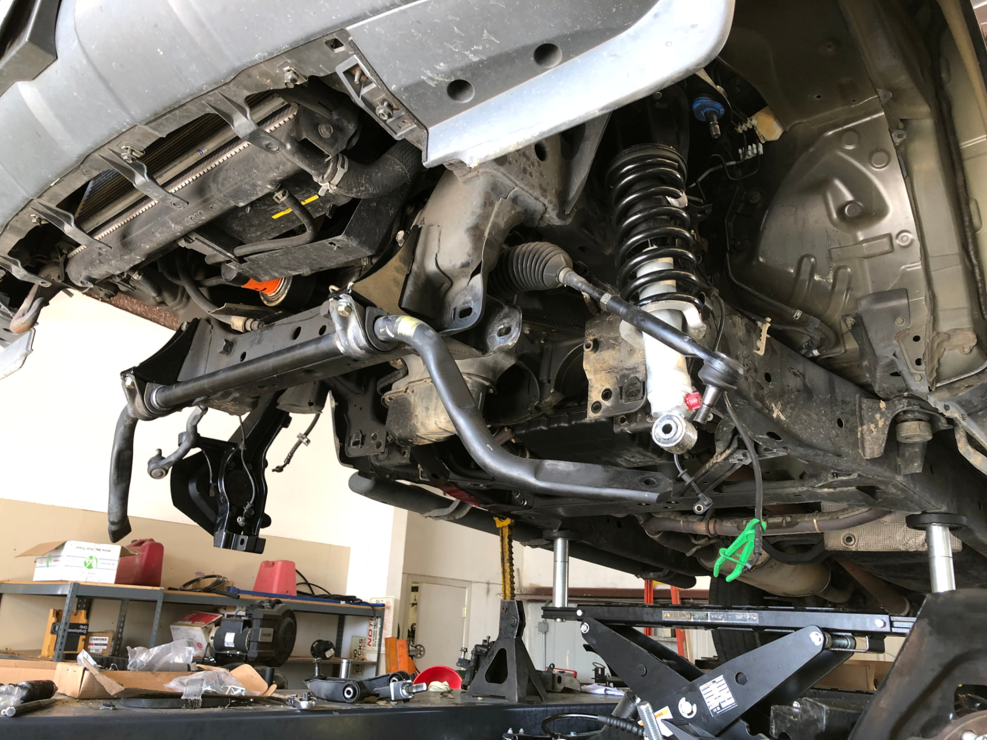 Vehicle suspension components being serviced on a lift
